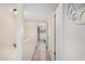Bright hallway with wood floors leads to a cozy bedroom with a big window at 8210 E Garfield St # K23, Scottsdale, AZ 85257