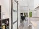 Hallway with gray sliding door and view into living room with plenty of natural light at 8210 E Garfield St # K23, Scottsdale, AZ 85257