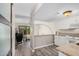 Open concept kitchen includes white cabinets, stone countertops, and views of the living space at 8210 E Garfield St # K23, Scottsdale, AZ 85257