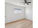 A bright bedroom featuring wood-look floors, a ceiling fan, and a window at 830 S Dobson Rd # 19, Mesa, AZ 85202