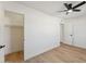 Bright bedroom with wood floors, a ceiling fan, and an open closet for ample storage at 830 S Dobson Rd # 19, Mesa, AZ 85202