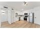 Bright kitchen featuring stainless steel appliances, white cabinetry, and subway tile backsplash with wood flooring at 830 S Dobson Rd # 19, Mesa, AZ 85202