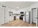 Modern kitchen with stainless steel appliances, white cabinets, ample storage, and wood flooring at 830 S Dobson Rd # 19, Mesa, AZ 85202