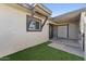 Private back patio featuring artificial grass, a window with wooden beam detail, and access to storage at 830 S Dobson Rd # 19, Mesa, AZ 85202