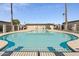 Community pool features bright blue water, surrounding palms and fencing at 830 S Dobson Rd # 19, Mesa, AZ 85202
