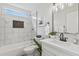 Updated bathroom featuring marble style tile and modern fixtures at 8620 W Denton Ln, Glendale, AZ 85305