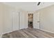 Neutral bedroom featuring wood-look flooring, large closet, and recessed lighting at 8620 W Denton Ln, Glendale, AZ 85305