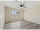 Comfortable bedroom with a ceiling fan, bright window, and wood-look flooring at 8620 W Denton Ln, Glendale, AZ 85305