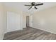 Bright bedroom featuring wood-look flooring, closet, and recessed lighting at 8620 W Denton Ln, Glendale, AZ 85305