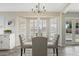 Inviting dining area with glass table and bay window overlooking the neighborhood at 8620 W Denton Ln, Glendale, AZ 85305