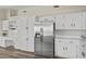 Bright white kitchen, complete with stainless steel appliances and white shaker cabinets at 8620 W Denton Ln, Glendale, AZ 85305