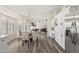Open-concept living space featuring a dining room, kitchen, and vaulted ceilings at 8620 W Denton Ln, Glendale, AZ 85305