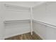 Clean and organized walk-in closet with wood floors and plenty of shelving and hanging space at 8620 W Denton Ln, Glendale, AZ 85305