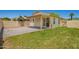 Backyard with a covered patio, landscaped with green grass and pavers at 8835 W John Cabot Rd, Peoria, AZ 85382