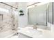 Bathroom featuring a shower-tub combination with marble tile, and a modern vanity at 8835 W John Cabot Rd, Peoria, AZ 85382
