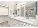 Elegant bathroom boasts double sinks, modern fixtures, and a spacious shower with tile surround at 8835 W John Cabot Rd, Peoria, AZ 85382