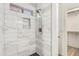 Updated shower with large white marble tile and black tile flooring at 8835 W John Cabot Rd, Peoria, AZ 85382