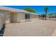 This ground level exterior shot features the entry and the gravel landscaping with palm trees at 8835 W John Cabot Rd, Peoria, AZ 85382