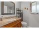 Bathroom featuring a vanity with granite countertop, a toilet, and an organizer at 10895 W Clair Dr, Sun City, AZ 85351