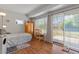Cozy bedroom boasting wood-look floors and sliding glass doors leading to outdoor patio at 10895 W Clair Dr, Sun City, AZ 85351