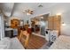 Bright bedroom featuring wood-look floors, ceiling fan, and sliding glass doors at 10895 W Clair Dr, Sun City, AZ 85351