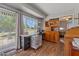 Bright bedroom with wood-look floors and large sliding glass doors to the back yard at 10895 W Clair Dr, Sun City, AZ 85351