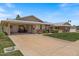 Charming single-story home featuring a covered carport, wide driveway, and well-maintained lawn at 10895 W Clair Dr, Sun City, AZ 85351