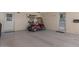 Spacious garage featuring a golf cart and ample parking at 10895 W Clair Dr, Sun City, AZ 85351
