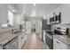 Well-lit kitchen featuring stainless steel appliances and granite countertops, ideal for cooking at 10895 W Clair Dr, Sun City, AZ 85351