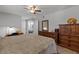 Bright main bedroom with natural light featuring a dresser, vanity, and bed at 10895 W Clair Dr, Sun City, AZ 85351