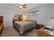 Comfortable main bedroom featuring a ceiling fan, a window, and a large bed at 10895 W Clair Dr, Sun City, AZ 85351