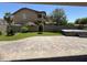Landscaped backyard with a hot tub, artificial grass, and brick-paved patio at 11249 N 161St Ave, Surprise, AZ 85379