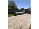 Backyard showcasing an swim spa surrounded by a brick-paved patio and artificial grass at 11249 N 161St Ave, Surprise, AZ 85379