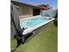 A backyard with an swim spa, artificial grass, and covered patio at 11249 N 161St Ave, Surprise, AZ 85379