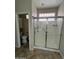 Bathroom featuring a glass enclosed shower and tile floors at 11249 N 161St Ave, Surprise, AZ 85379