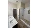 Bathroom featuring dual sinks and a stylish walk-in shower with pebble accents at 11249 N 161St Ave, Surprise, AZ 85379
