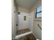 Modern bathroom featuring walk-in shower with rock floor and window for natural light at 11249 N 161St Ave, Surprise, AZ 85379