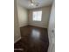 Bedroom featuring wood-look flooring, ceiling fan, and a window for natural light at 11249 N 161St Ave, Surprise, AZ 85379