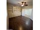 Spacious bedroom featuring hardwood floors, built-in shelving, and ceiling fan at 11249 N 161St Ave, Surprise, AZ 85379
