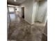 Spacious hallway featuring neutral tile flooring and bright, clean walls at 11249 N 161St Ave, Surprise, AZ 85379
