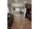 Eat-in kitchen with dark cabinets, granite countertops, stainless appliances, and a dining area at 11249 N 161St Ave, Surprise, AZ 85379
