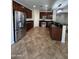 Spacious kitchen with dark cabinets, stainless steel appliances, and a breakfast bar at 11249 N 161St Ave, Surprise, AZ 85379