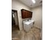 Functional laundry room equipped with a washer, dryer, and upper storage cabinets at 11249 N 161St Ave, Surprise, AZ 85379