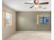 Neutral bedroom with two windows, ceiling fan, and plush carpet at 11724 N 148Th Ave, Surprise, AZ 85379
