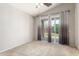 Bedroom with neutral carpet, ceiling fan, and sliding glass door to outdoor space at 11724 N 148Th Ave, Surprise, AZ 85379