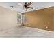 Spacious bedroom featuring a ceiling fan, neutral carpet, and dual windows for natural light at 11724 N 148Th Ave, Surprise, AZ 85379