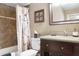 Traditional bathroom featuring a vanity, framed mirror, and a shower-tub combo with a curtain at 12212 N 66Th St, Scottsdale, AZ 85254