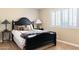 Comfortable bedroom with dark wood furniture, decorative lamps, window shutters, and hardwood flooring at 12212 N 66Th St, Scottsdale, AZ 85254