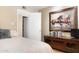 Cozy bedroom with wood floors, a television, a closet, and decorative artwork at 12212 N 66Th St, Scottsdale, AZ 85254