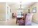 Charming dining room featuring a wood table, upholstered chairs, and a window with plantation shutters at 12212 N 66Th St, Scottsdale, AZ 85254
